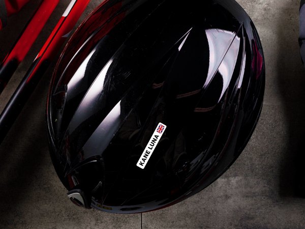 White name sticker with flag on a black ski helmet