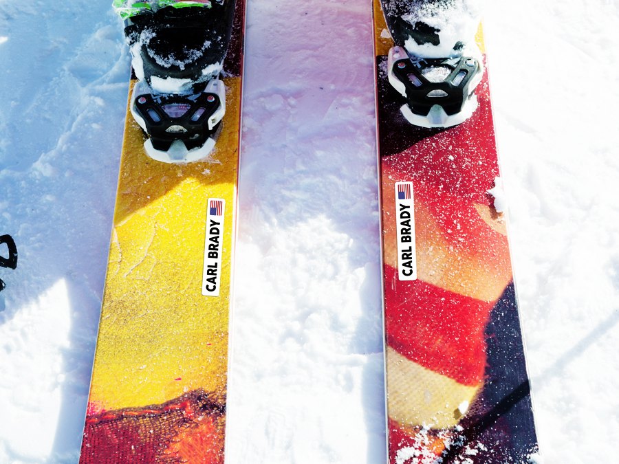 White name stickers with flag on the top of two skis